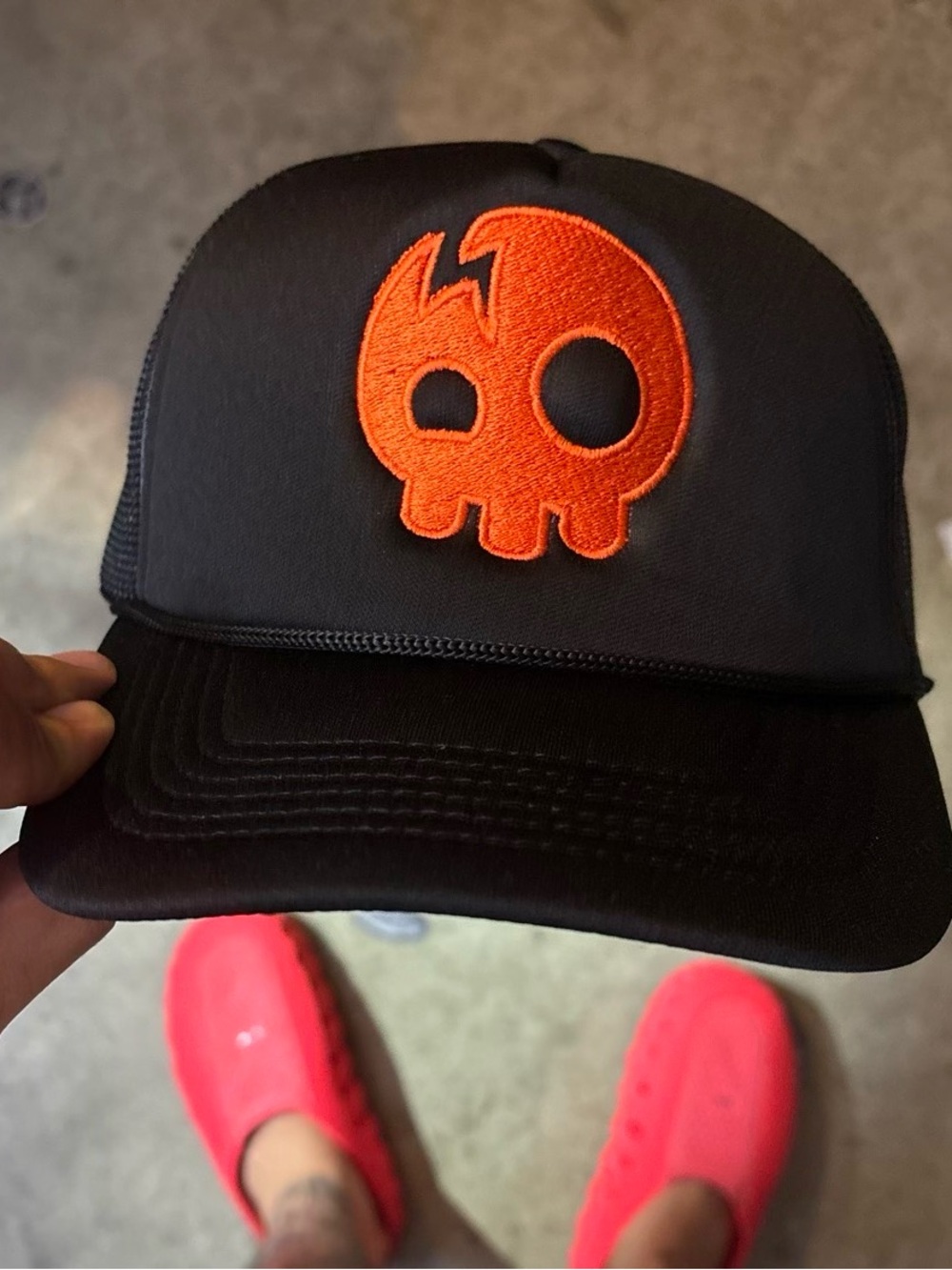 The Living Tombstone skull logo trucker hat